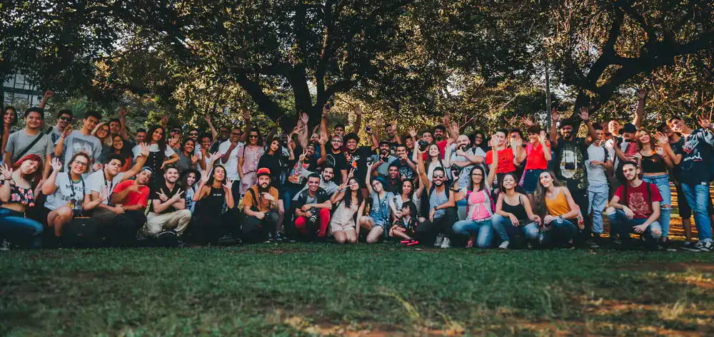 A large group of friends and colleagues posing together at the indoor adventure park